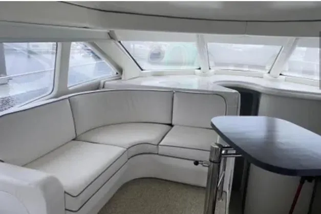 Slide: The Image of Luxurious interior of a 2007 Sea Ray 44 Sedan Bridge yacht with white seating. - 16