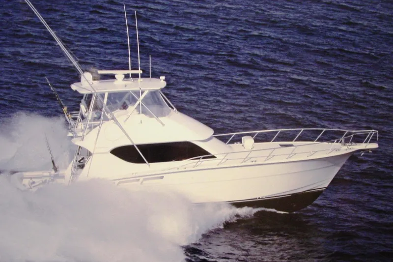 The Image of 2005 Hatteras 50 Convertible yacht cruising through ocean waves. - 0