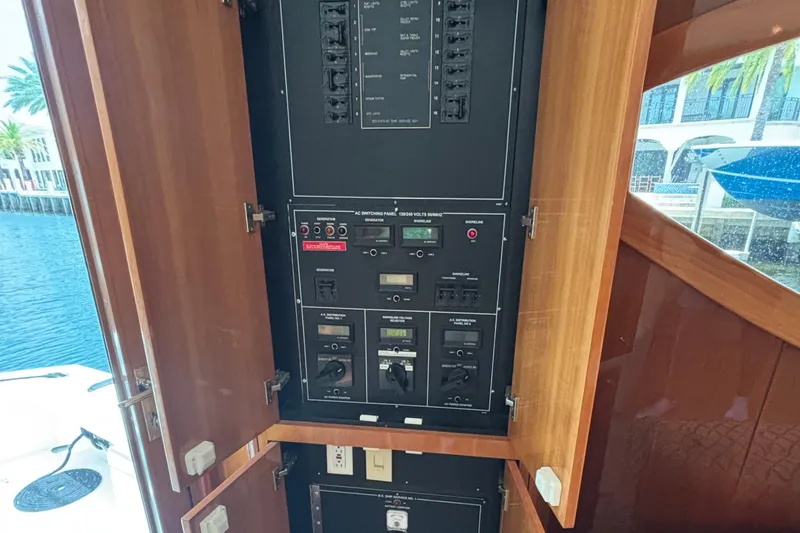 Slide: The Image of Electrical panel inside a 2005 Hatteras 50 Convertible yacht, showcasing circuit breakers and controls. - 27