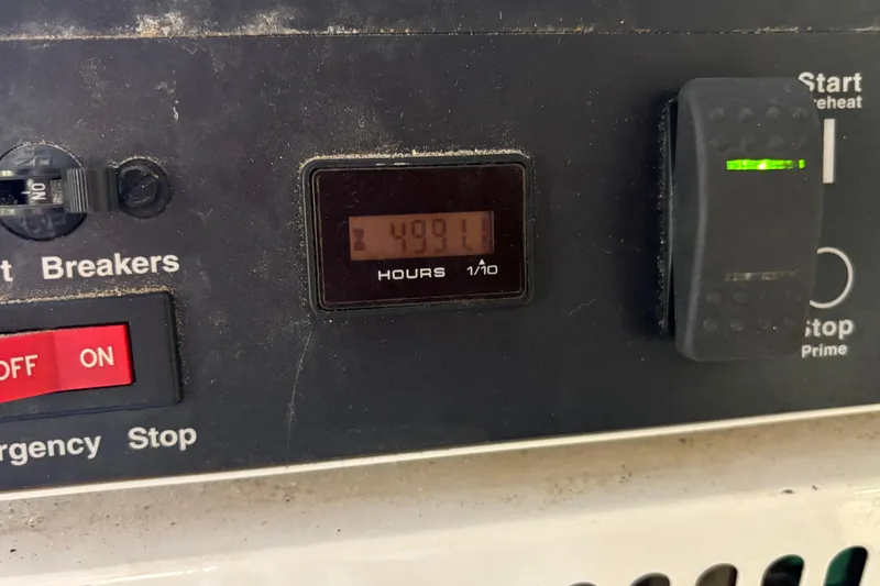 Slide: The Image of Control panel of a 2005 Hatteras 50 Convertible showing 4991 hours. - 33