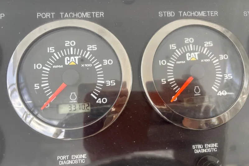 Slide: The Image of Tachometers on a 2005 Hatteras 50 Convertible boat dashboard, showing engine RPMs. - 13