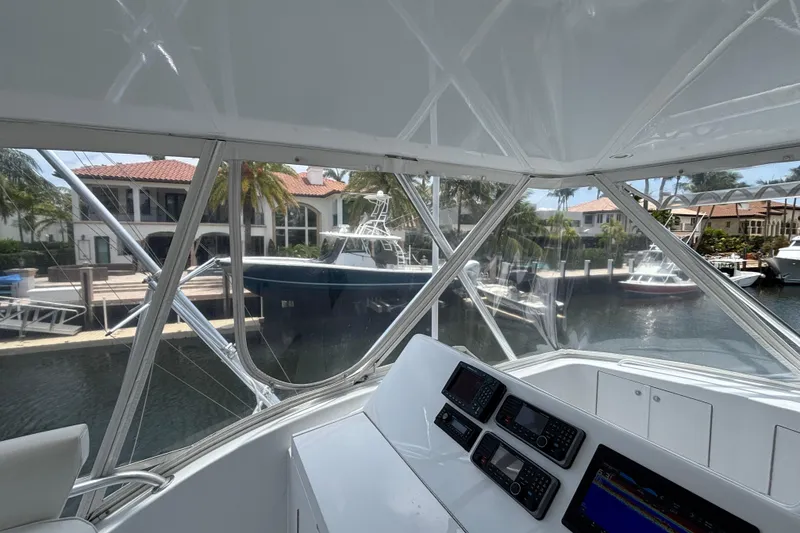 Slide: The Image of Interior view of a 2005 Hatteras 50 Convertible yacht docked near waterfront homes. - 10
