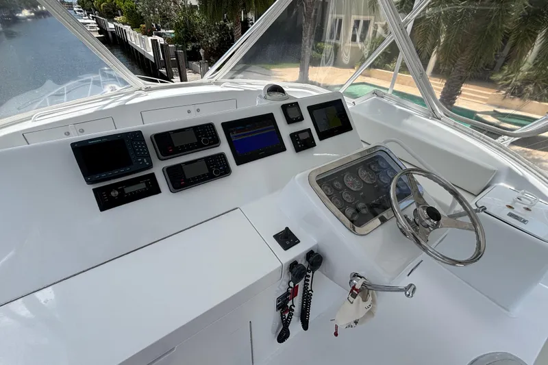 Slide: The Image of Helm of 2005 Hatteras 50 Convertible yacht with navigation instruments and steering wheel. - 8