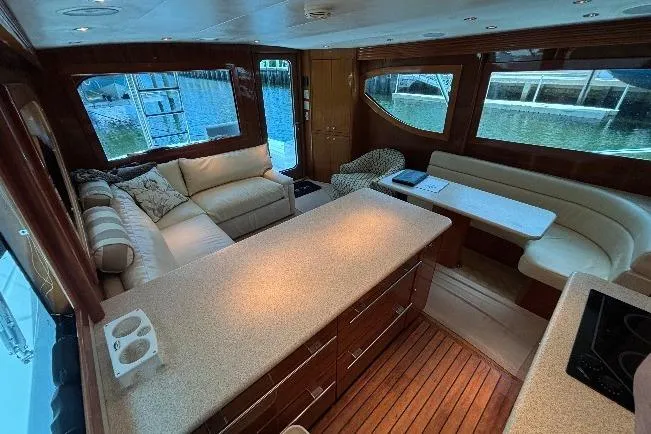 Slide: The Image of Luxurious interior of a 2005 Hatteras 50 Convertible yacht with elegant seating and wood finishes. - 14