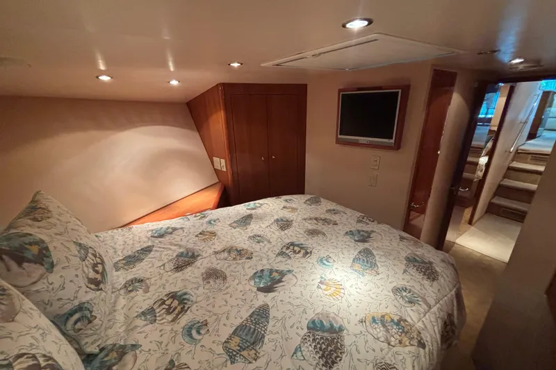 Slide: The Image of Luxurious bedroom interior of 2005 Hatteras 50 Convertible yacht with patterned bedding. - 17