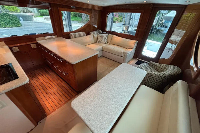 Slide: The Image of Luxurious interior of 2005 Hatteras 50 Convertible yacht with elegant seating and wooden finishes. - 15