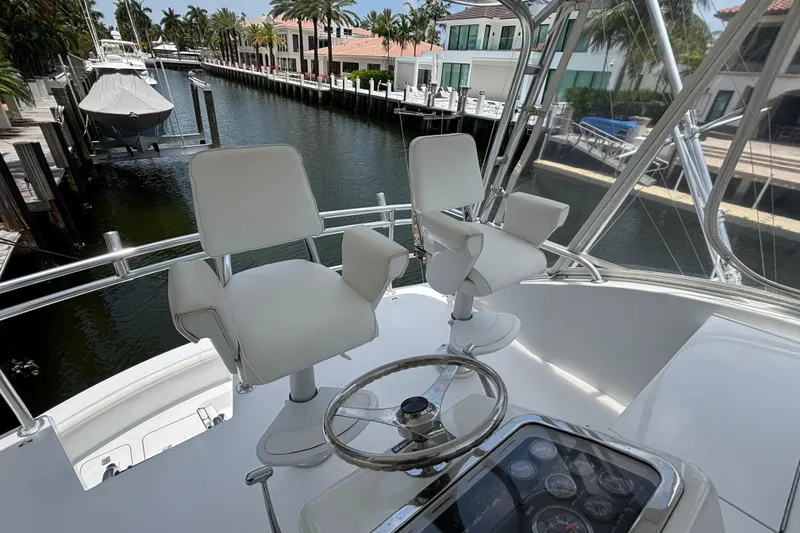 Slide: The Image of Flybridge of 2005 Hatteras 50 Convertible yacht with helm chairs and steering wheel. - 7