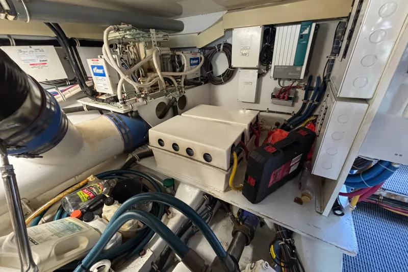Slide: The Image of Engine room of a 2005 Hatteras 50 Convertible yacht, showcasing mechanical components. - 31