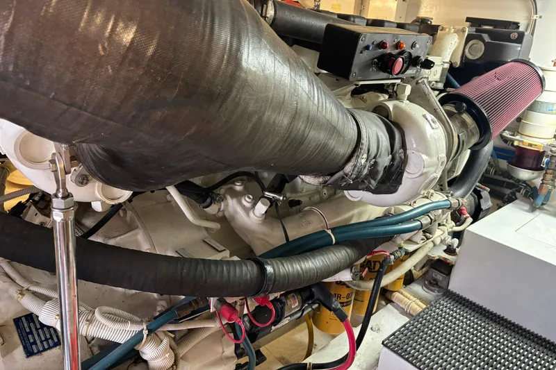Slide: The Image of Engine room of a 2005 Hatteras 50 Convertible yacht, showcasing detailed machinery components. - 29
