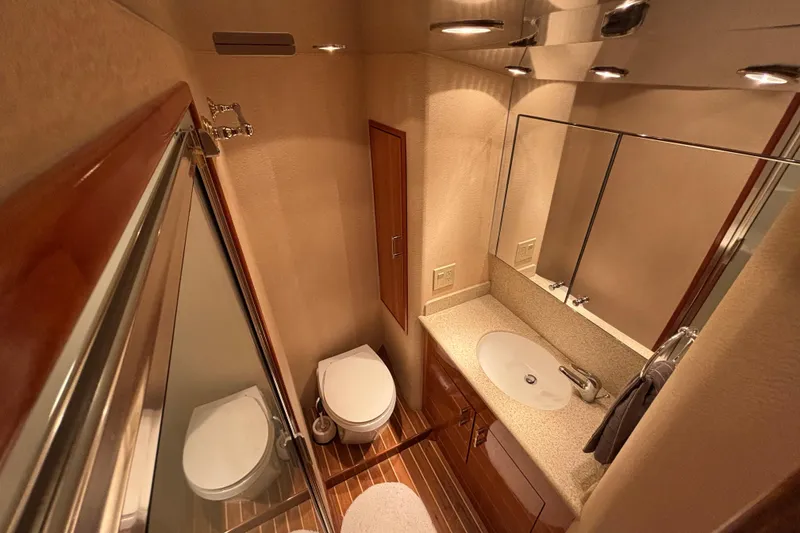 Slide: The Image of Luxurious bathroom interior of 2005 Hatteras 50 Convertible yacht with modern fixtures and wood accents. - 22