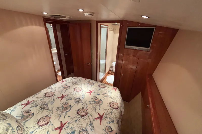 Slide: The Image of Interior of 2005 Hatteras 50 Convertible yacht bedroom with ensuite bathroom. - 21