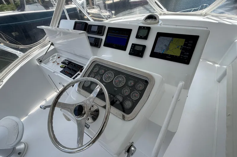 Slide: The Image of Helm of 2005 Hatteras 50 Convertible yacht with navigation instruments and steering wheel. - 9