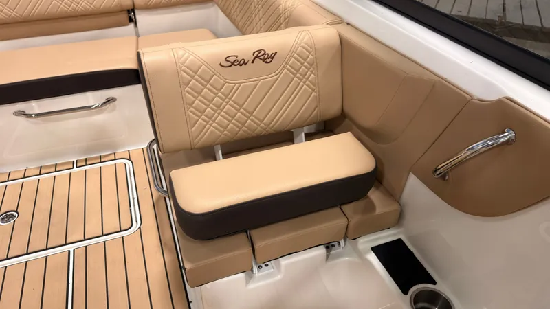 Slide: The Image of The 2026 Sea Ray SDX 230 features luxurious beige upholstery with quilted design and a cup holder. - 37