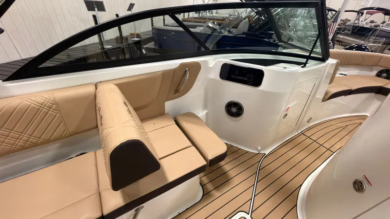 Slide: The Image of The image shows the interior of a Sea Ray SDX 230 boat with beige upholstery and wood flooring. - 35