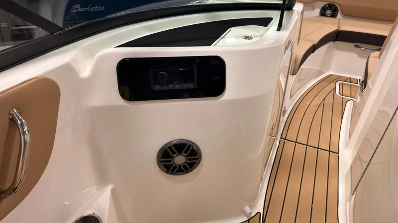 Slide: The Image of The image shows the cockpit of a 2026 Sea Ray SDX 230 with sleek seating and wood flooring. - 38