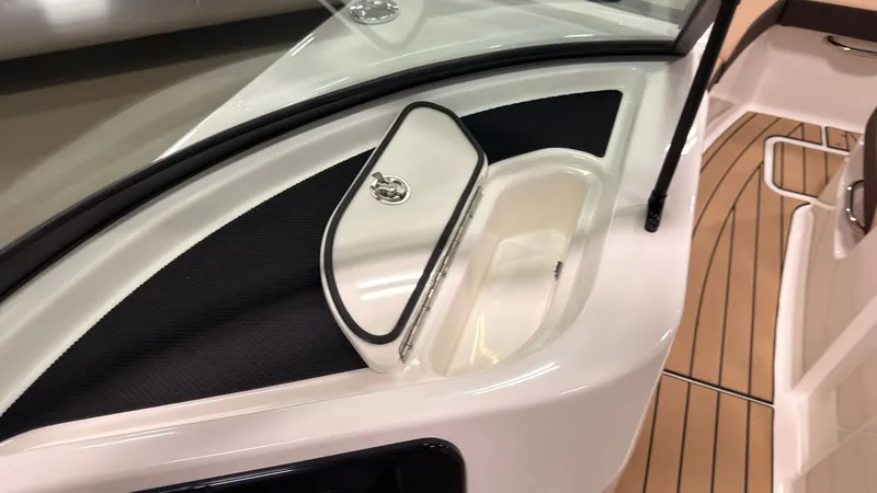 Slide: The Image of Close-up of a Sea Ray SDX 230 boat showing storage compartment and teak flooring. - 41