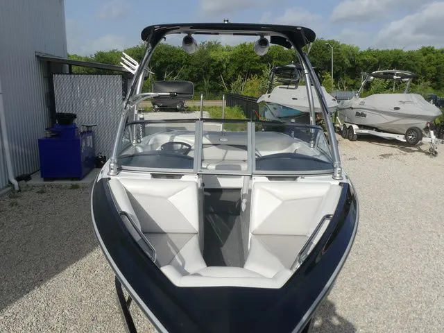 Slide: The Image of 2008 Tigé Z1 with sleek design and comfortable seating, parked on a gravel lot. - 12