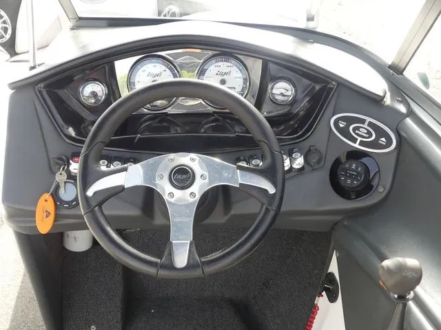 Slide: The Image of The image shows the helm of a 2008 Tigé Z1 boat with modern instruments. - 25