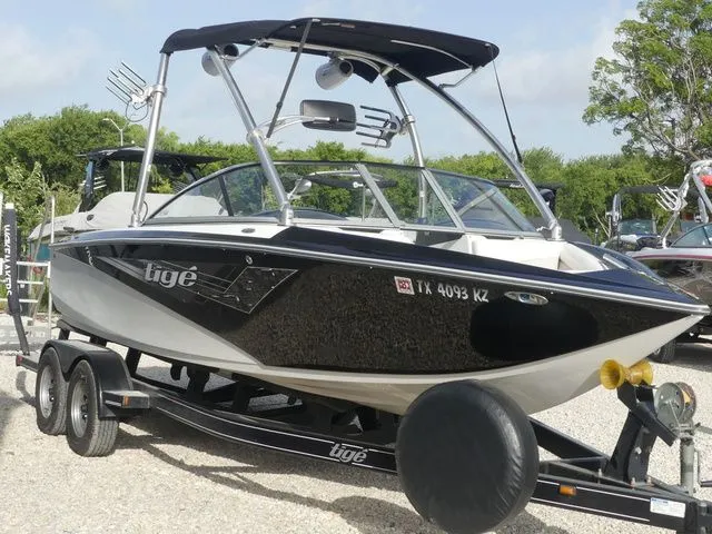 Slide: The Image of A black and white boat on a trailer, featuring a Bimini top and sleek design. - 4