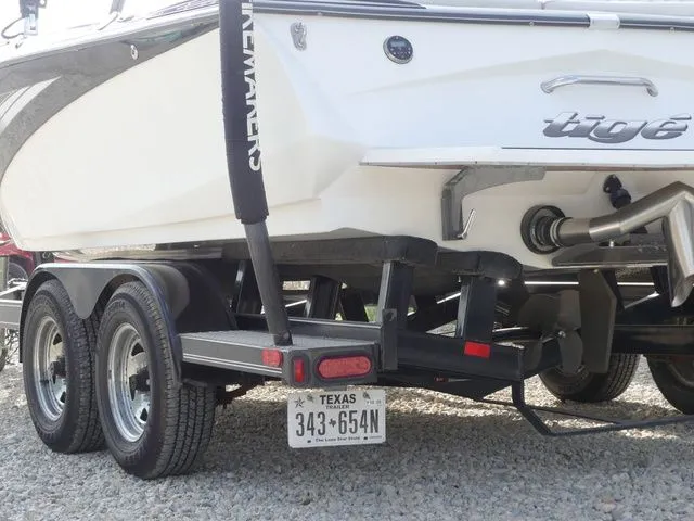 Slide: The Image of Rear view of a 2008 Tigé Z1 boat on a trailer, featuring a Texas license plate. - 8