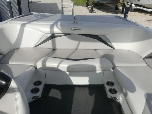Slide: The Image of The image shows the interior of a 2008 Tigé Z1 boat with white upholstery and cup holders. - 15