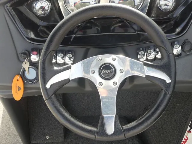 Slide: The Image of The image shows the steering wheel of a 2008 Tigé Z1 boat with dashboard. - 26