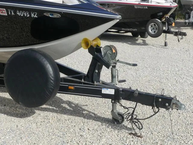 Slide: The Image of A 2008 Tigé Z1 boat on a trailer on gravel. - 11