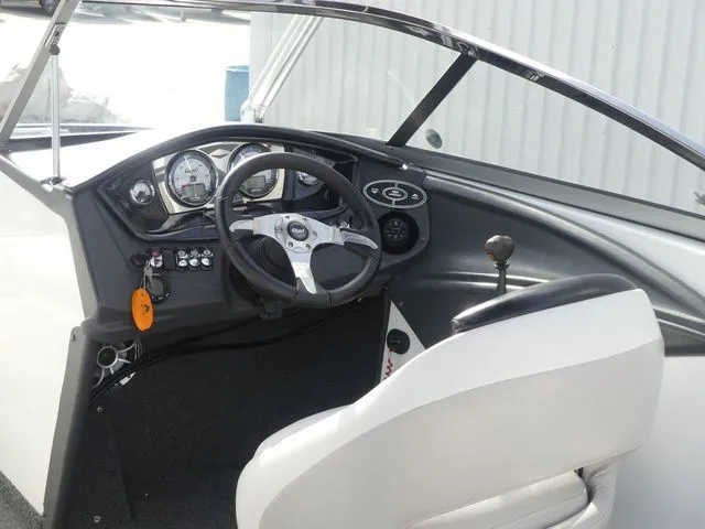 Slide: The Image of The image shows the cockpit of a 2008 Tigé Z1 boat with steering wheel and instruments. - 17