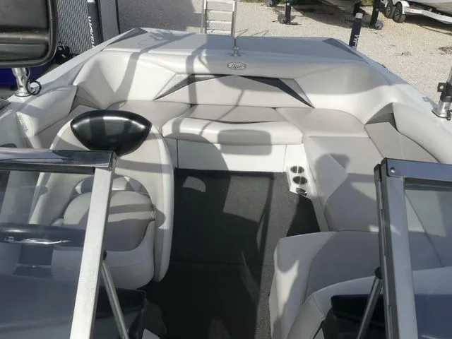 Slide: The Image of Interior view of a 2008 Tigé Z1 boat with gray upholstery and glass windows. - 14