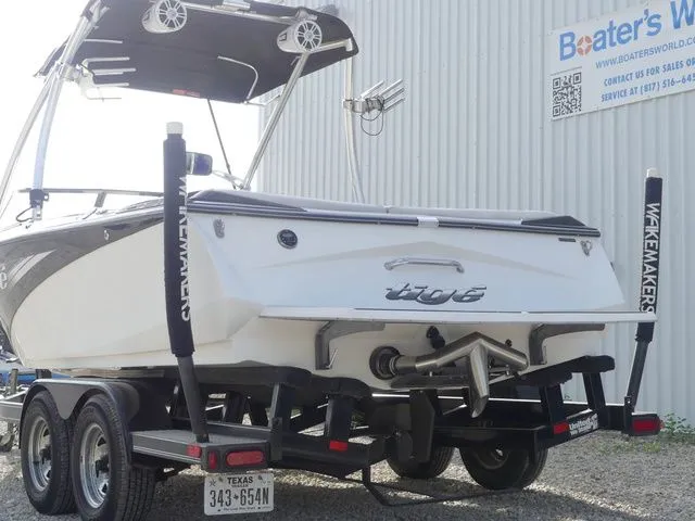 Slide: The Image of A 2008 Tigé Z1 boat on a trailer, featuring a tower and wakeboard racks. - 7