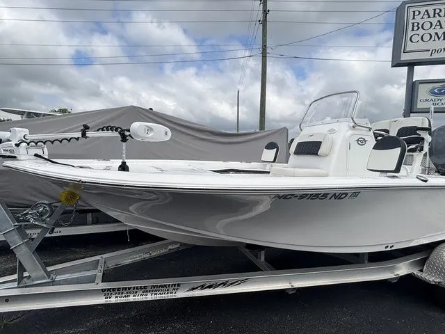 Slide: The Image of A 2024 Tidewater 2210 Carolina Bay boat on a trailer, featuring a white hull and helm console. - 5