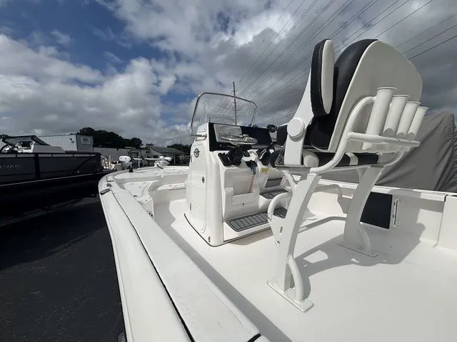 Slide: The Image of The image shows a 2024 Tidewater 2210 Carolina Bay boat with a white helm and seating. - 3