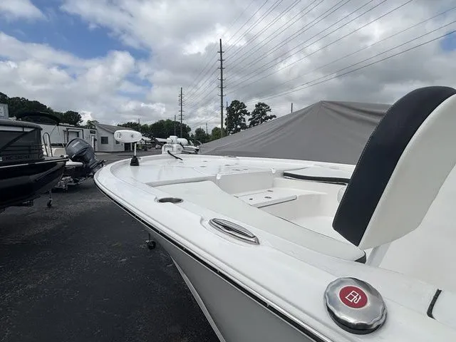 Slide: The Image of The image shows a white boat parked on a lot. It features a modern design. - 6