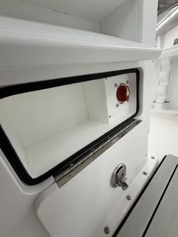 Slide: The Image of A white storage compartment with a red cover and metal latch. - 13