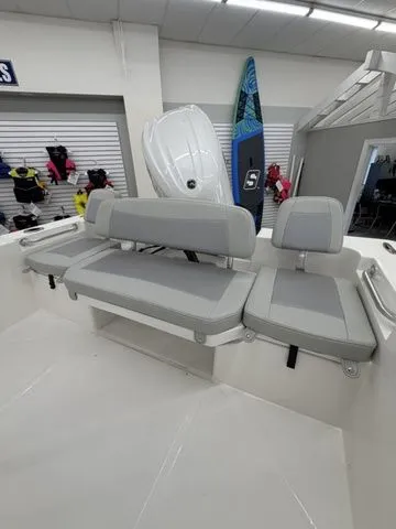 Slide: The Image of The image shows the gray seating of a Bay Rider 2260 FS boat in a showroom. - 14