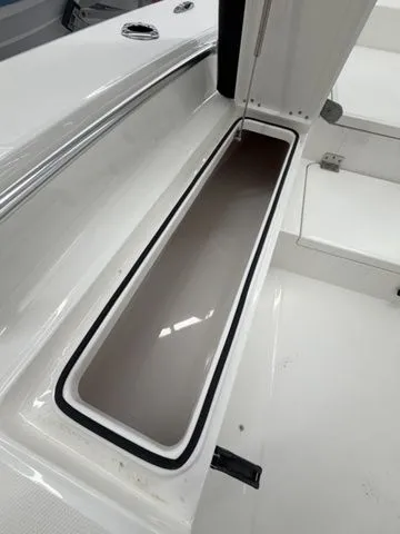 Slide: The Image of An open storage compartment on a 2026 Bay Rider 2260 FS boat. - 7