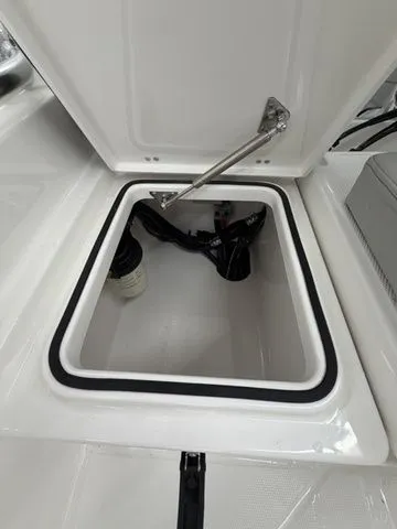 Slide: The Image of View of an open storage compartment on a boat with a hydraulic arm. - 16