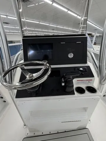 Slide: The Image of The image shows the helm of a Bay Rider 2260 FS boat with a steering wheel and controls. - 12