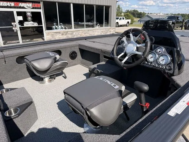 Slide: The Image of The image shows the cockpit of a Lund 1875 Pro-V Bass XS boat with two seats and a helm. - 6