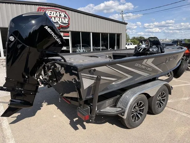Slide: The Image of A Lund 1875 Pro-V Bass XS boat on a trailer in front of a building. - 3