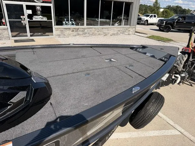 Slide: The Image of The image shows the deck of a Lund 1875 Pro-V Bass XS boat on a trailer. - 7