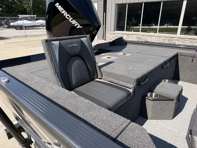 Slide: The Image of The image shows the interior of a Lund 1875 Pro-V Bass XS boat with a Mercury engine. - 5