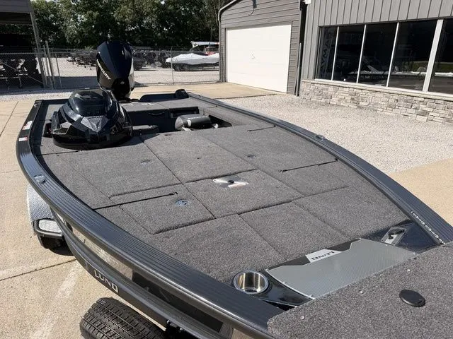 Slide: The Image of The image shows a gray fishing boat with a large, flat deck and an outboard motor. - 8