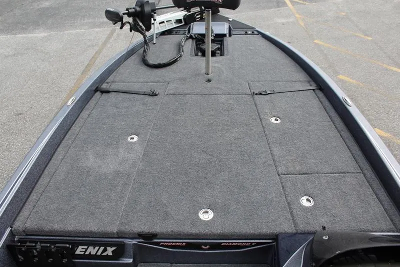 Slide: The Image of 2027 Phoenix 921 Elite X boat deck with carpeted surface and storage compartments. - 21