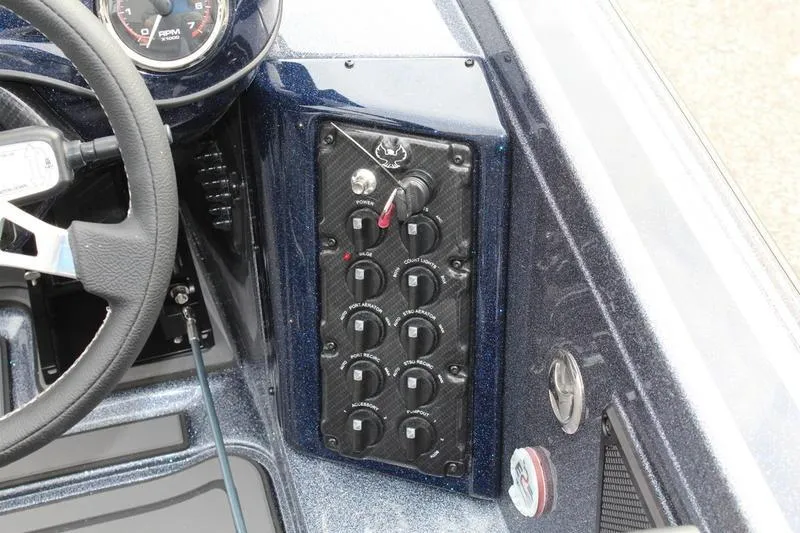 Slide: The Image of Dashboard controls of 2027 Phoenix 921 Elite X boat with steering wheel and switches. - 13
