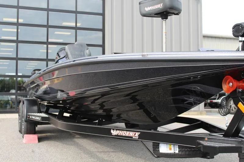 Slide: The Image of 2027 Phoenix 921 Elite X boat on trailer, parked outside a building. - 5