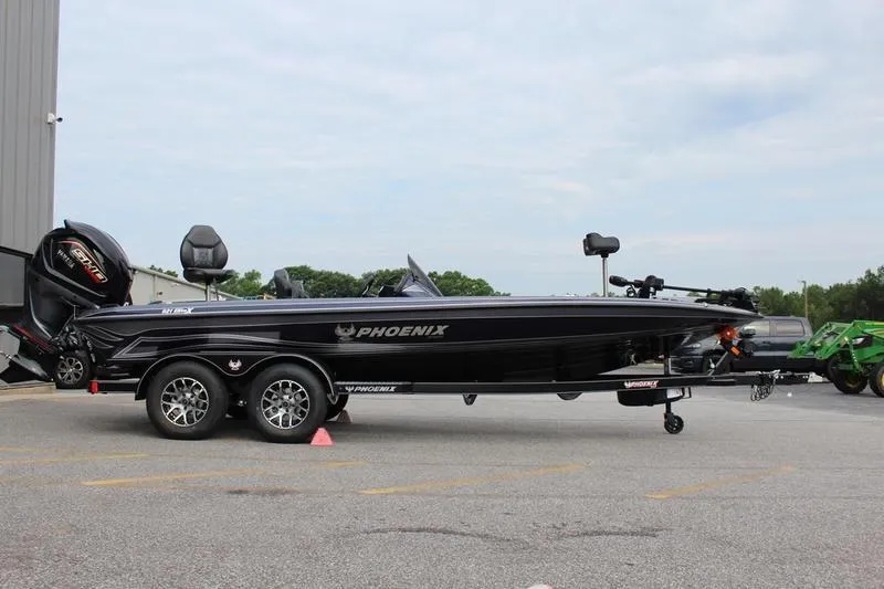 The Image of 2027 Phoenix 921 Elite X boat on trailer, parked outdoors. - 1