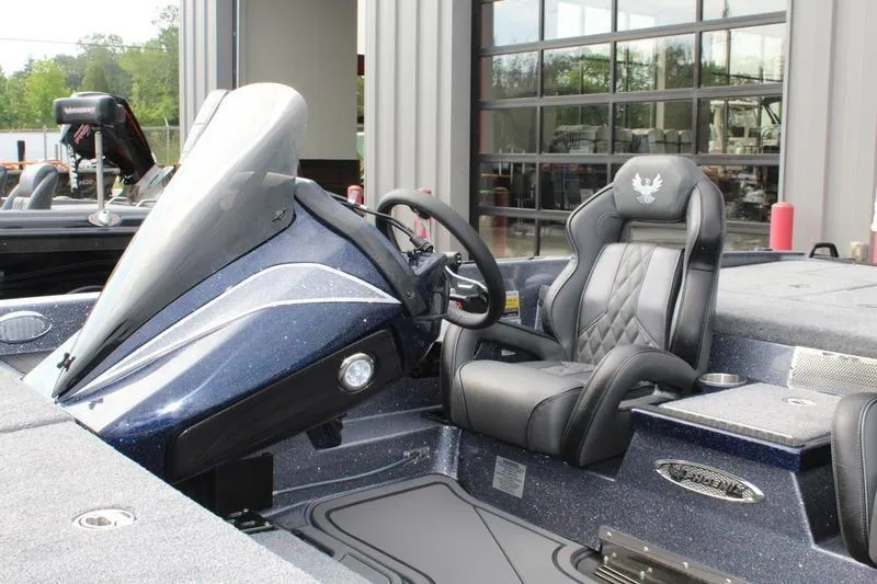 Slide: The Image of 2027 Phoenix 921 Elite X boat interior with sleek dashboard and comfortable seating. - 14