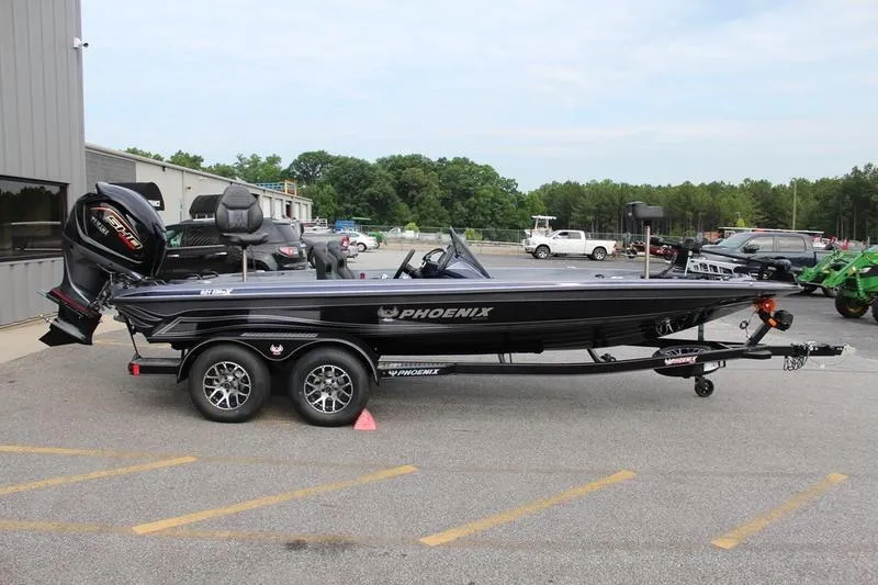 Slide: The Image of 2027 Phoenix 921 Elite X boat on trailer, parked outdoors near a building. - 4