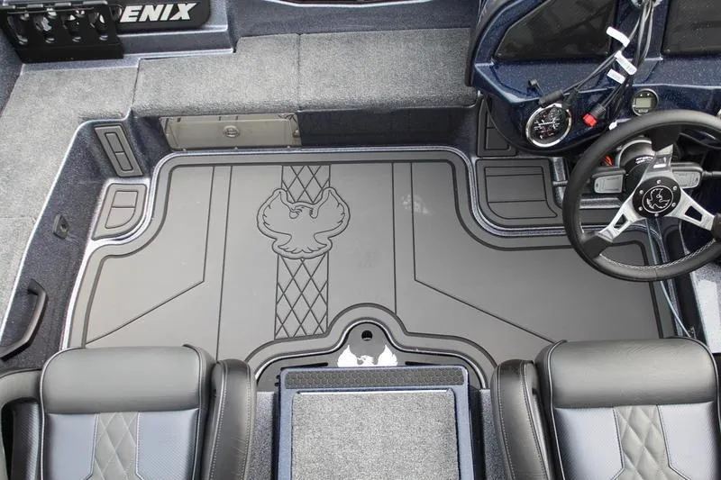 Slide: The Image of Interior of 2027 Phoenix 921 Elite X boat with detailed flooring and steering wheel. - 12